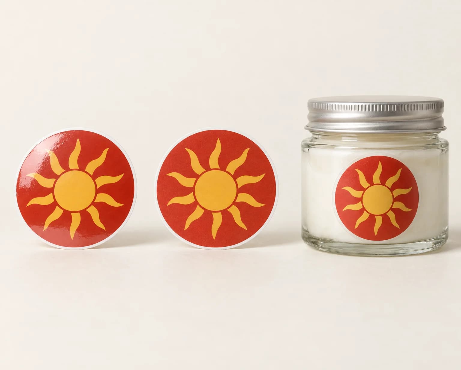 The same round sticker in gloss vinyl, matte vinyl and clear vinyl, the clear one on a glass jar of white cream