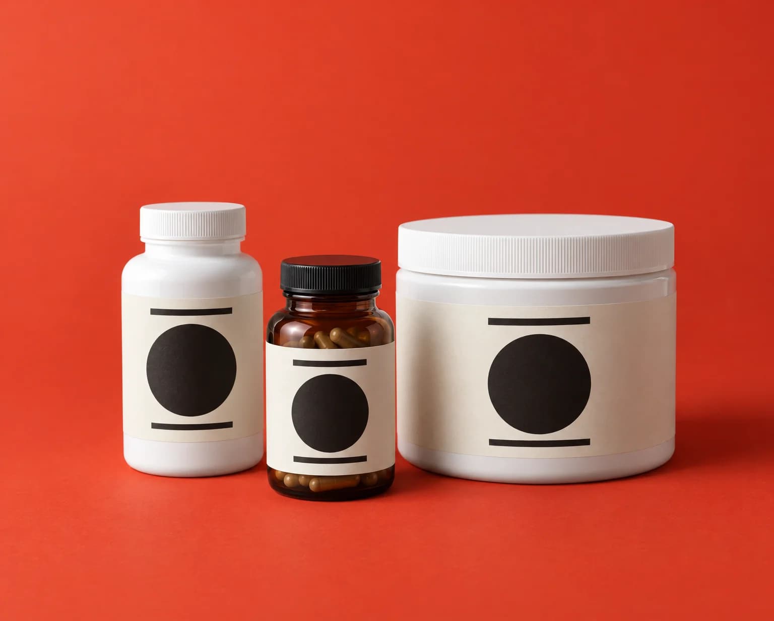 A white capsule bottle, an amber capsule bottle and a white powder tub with cream and black labels on a tomato red backdrop